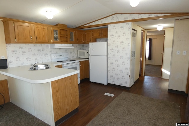 kitchen with kitchen peninsula, dark hardwood / wood-style flooring, white appliances, lofted ceiling, and range hood