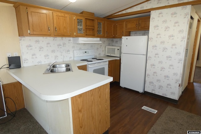 kitchen with white appliances, ventilation hood, sink, vaulted ceiling, and kitchen peninsula