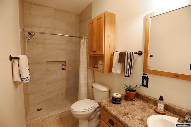 bathroom featuring tile patterned floors, vanity, curtained shower, and toilet