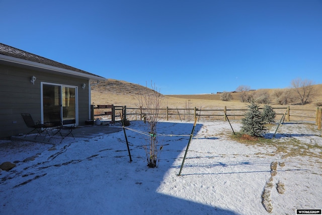 view of yard with a mountain view and a rural view