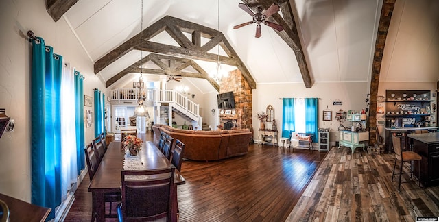 dining room with beam ceiling, dark hardwood / wood-style flooring, high vaulted ceiling, and ceiling fan with notable chandelier