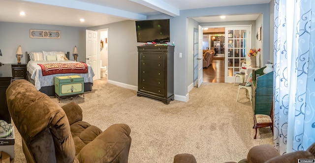 carpeted bedroom featuring beam ceiling