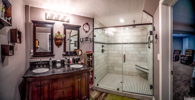 bathroom featuring vanity, wood-type flooring, a textured ceiling, and walk in shower