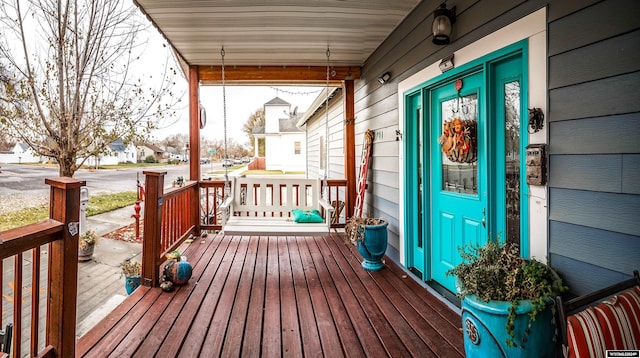 wooden terrace featuring covered porch