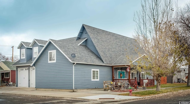 view of property exterior featuring a porch and a garage