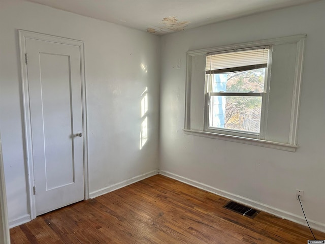 empty room featuring dark wood-type flooring