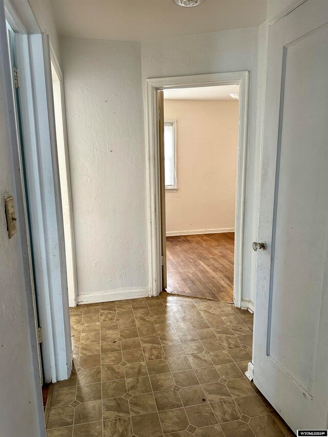 corridor with dark wood-type flooring