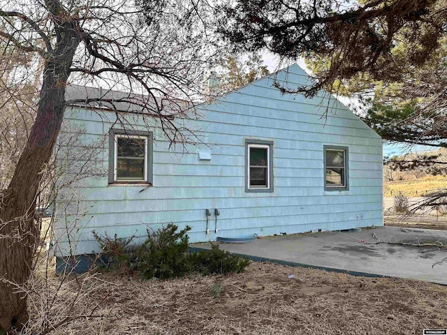 view of side of home with a patio