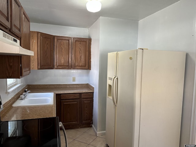1323 Cherry St, Rawlins, WY 82301 - kitchen featuring white fridge with ice dispenser, under cabinet range hood, electric stove, and light tile patterned flooring