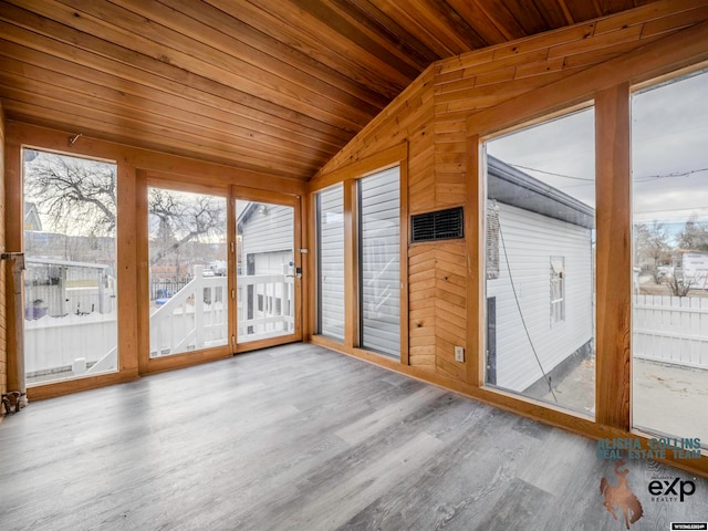 unfurnished sunroom featuring wood ceiling and vaulted ceiling