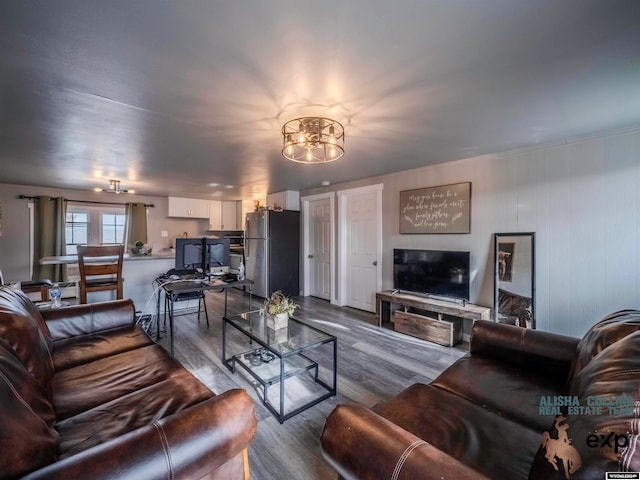 living room featuring light hardwood / wood-style flooring and a notable chandelier