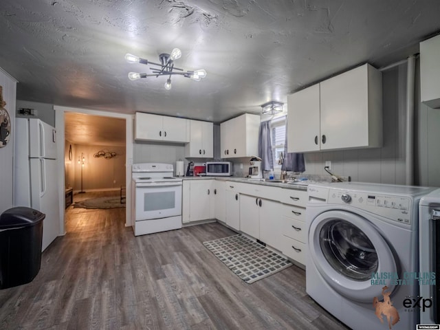 kitchen with hardwood / wood-style flooring, white cabinetry, washer / dryer, and white appliances