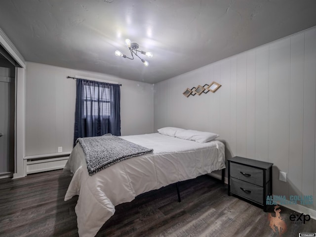 bedroom featuring a baseboard radiator, dark hardwood / wood-style floors, and a notable chandelier