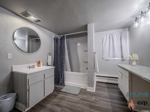 bathroom with a shower with shower curtain, vanity, wood-type flooring, and a baseboard heating unit