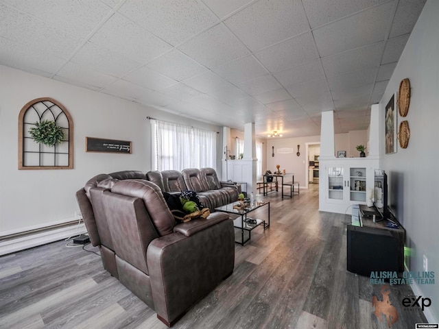 living room featuring hardwood / wood-style flooring, a paneled ceiling, and a baseboard radiator