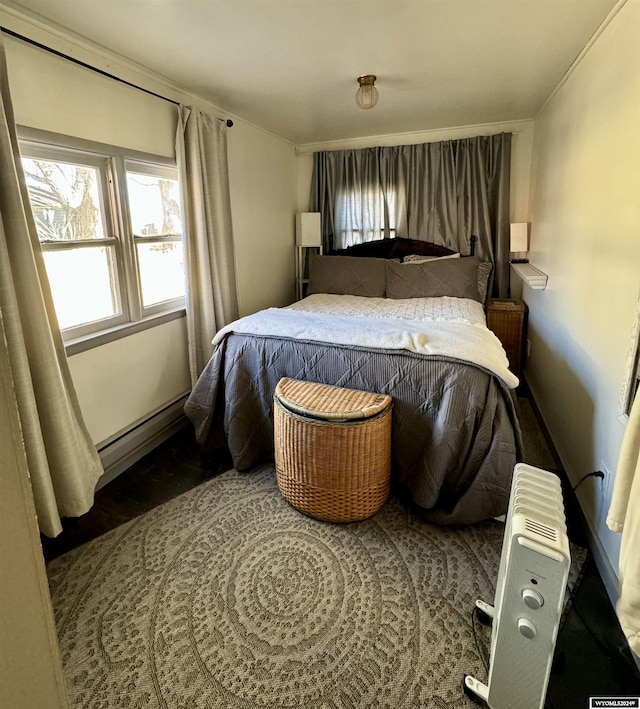 bedroom featuring baseboard heating and radiator