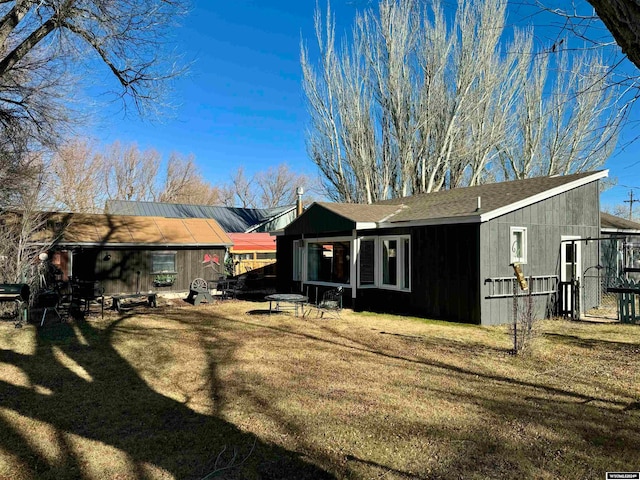 rear view of property with a lawn