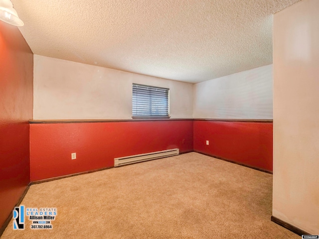 unfurnished room with light colored carpet, a textured ceiling, and a baseboard radiator