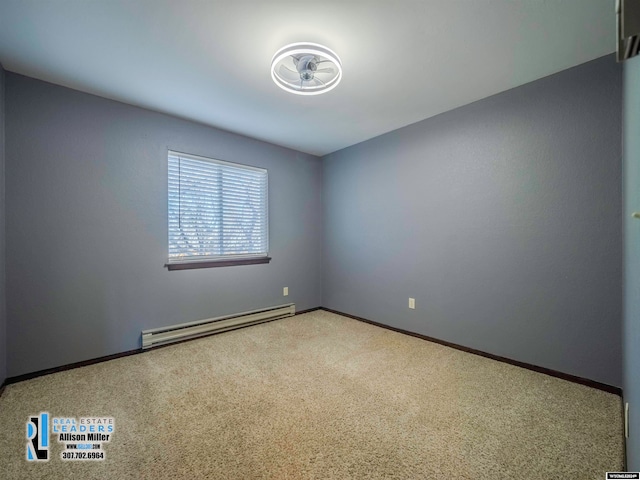 carpeted empty room featuring a baseboard radiator