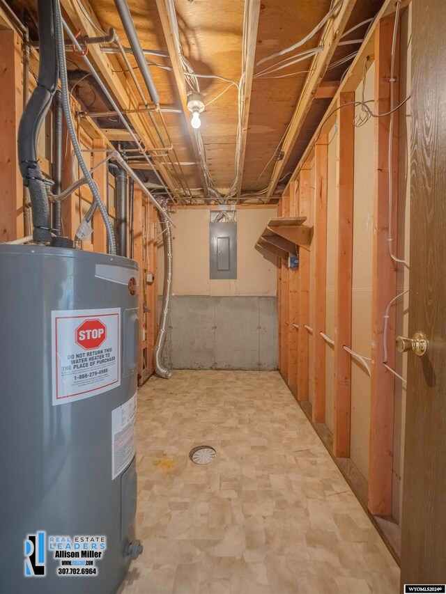 basement featuring electric water heater and electric panel