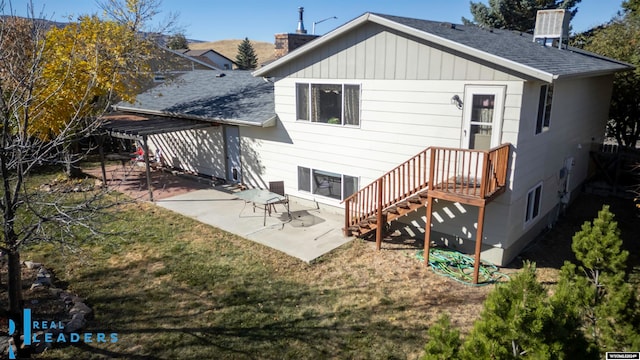 rear view of property with a lawn and a patio area