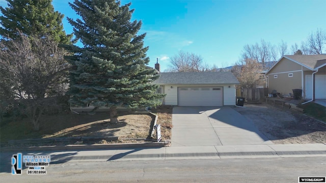 view of front of house with an outdoor structure and a garage