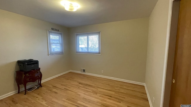 unfurnished room with light hardwood / wood-style floors