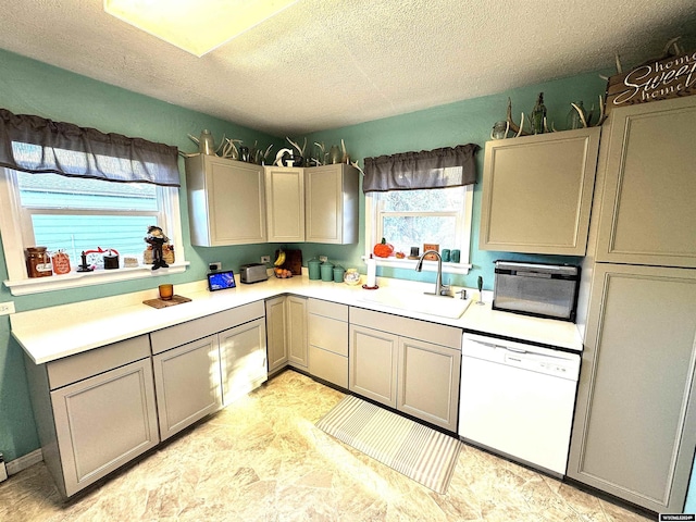 kitchen featuring dishwasher, a textured ceiling, and sink