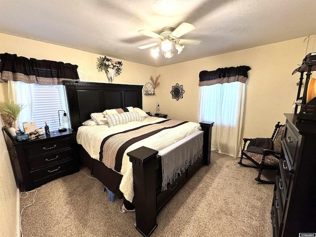 carpeted bedroom featuring a textured ceiling and ceiling fan