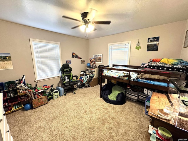 carpeted bedroom with multiple windows and ceiling fan