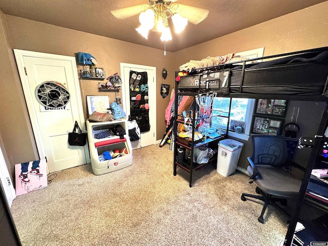 bedroom featuring carpet, a textured ceiling, and ceiling fan