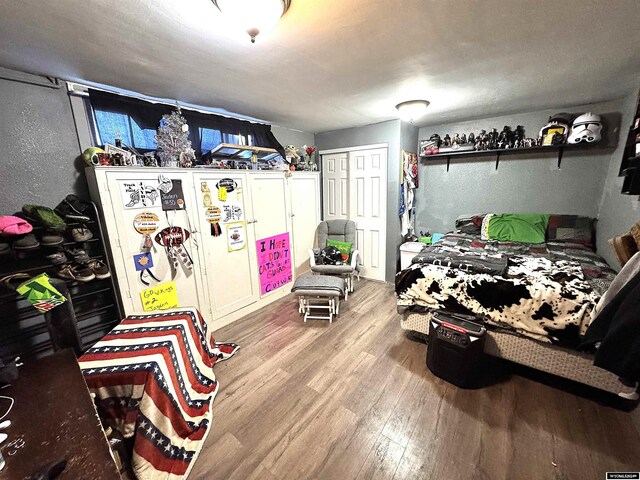 bedroom with light hardwood / wood-style flooring and a closet