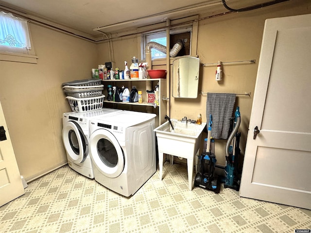 clothes washing area with separate washer and dryer