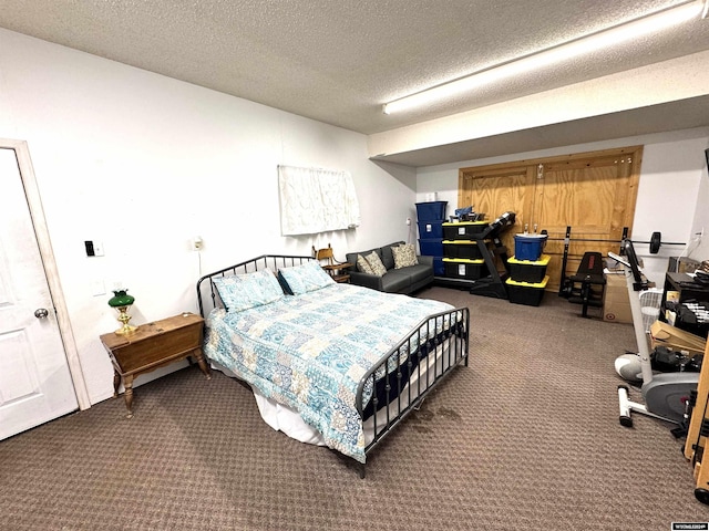 bedroom featuring carpet floors and a textured ceiling