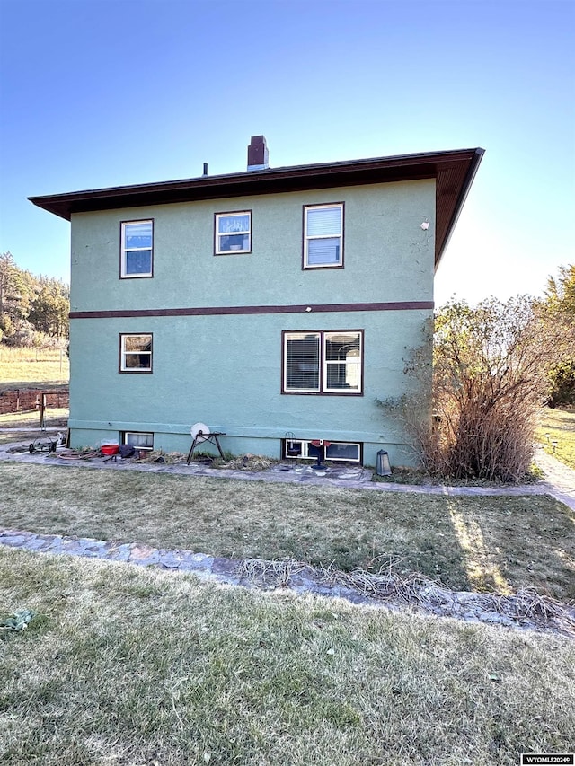 rear view of property with a yard