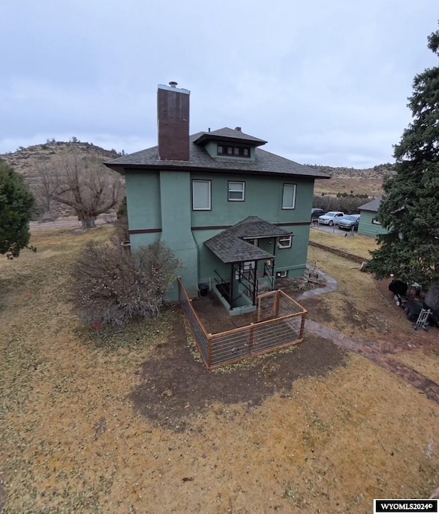 back of house with a mountain view