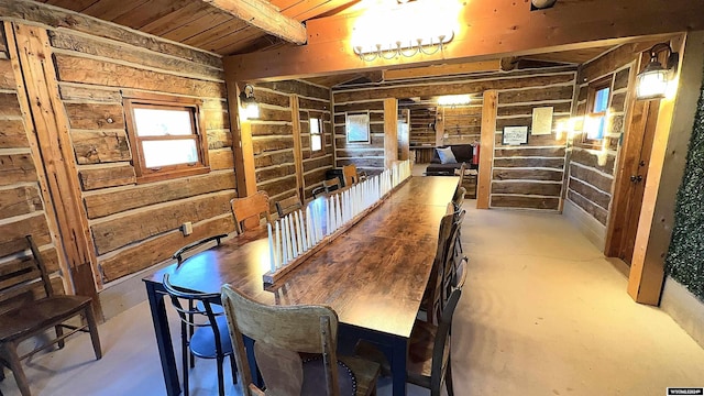 dining space with concrete floors and wooden ceiling