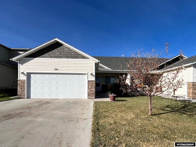 view of front of home with a front yard and a garage