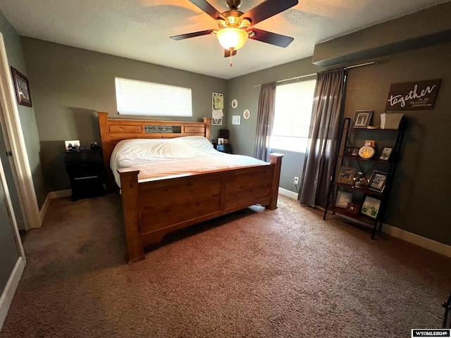 carpeted bedroom featuring a textured ceiling and ceiling fan