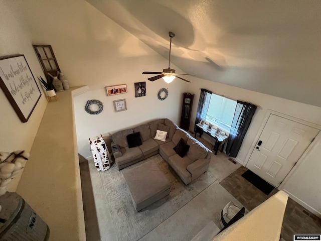 living room featuring ceiling fan and lofted ceiling