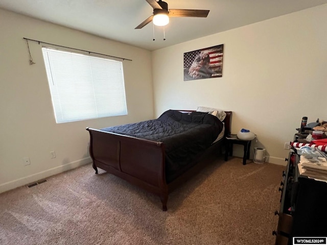 bedroom with multiple windows, carpet flooring, and ceiling fan