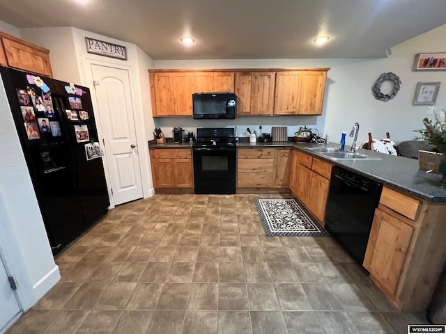 kitchen with black appliances, kitchen peninsula, and sink