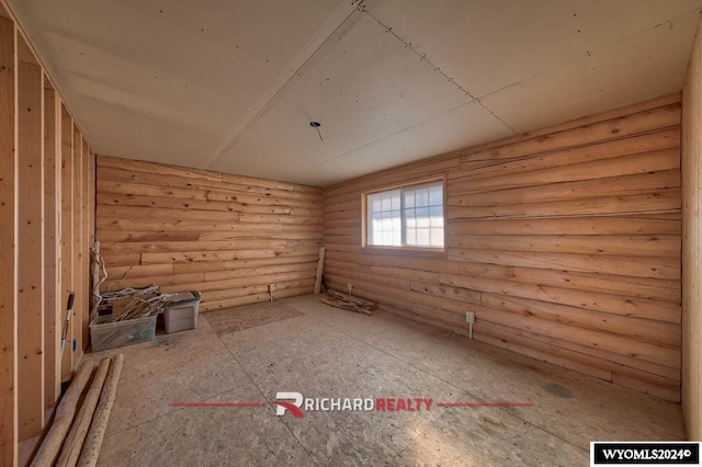 311 Bridge Ave, Worland, WY 82401 - unfurnished room featuring log walls