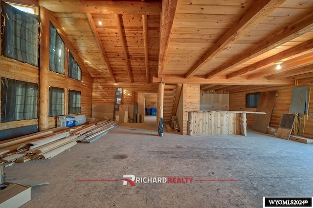 interior space featuring lofted ceiling, electric panel, and wooden ceiling