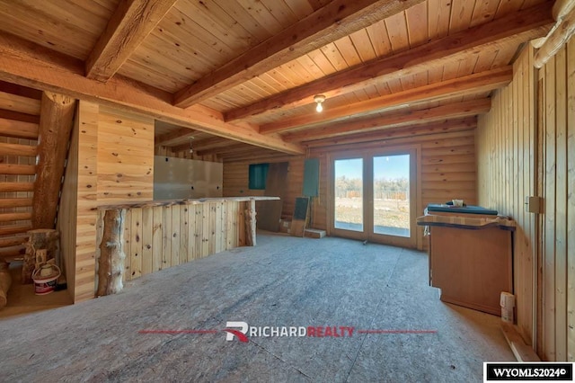 311 Bridge Ave, Worland, WY 82401 - unfurnished living room with a wood ceiling with exposed beams, light carpet, and log walls
