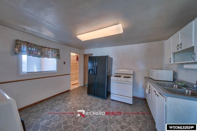 323 Bridge Ave, Worland, WY 82401 - kitchen featuring white appliances, white cabinetry, and dark stone finish floors