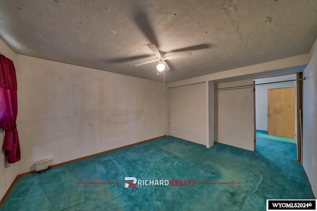 unfurnished bedroom with ceiling fan, dark carpet, and a textured ceiling