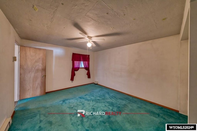 carpeted empty room featuring baseboard heating and ceiling fan