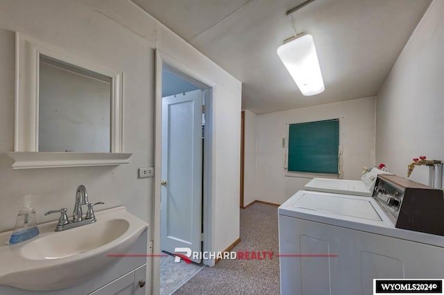 laundry area with washer and dryer, sink, and light carpet