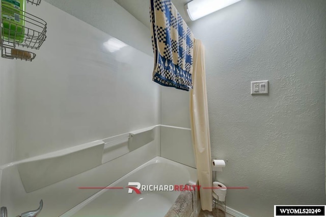 323 Bridge Ave, Worland, WY 82401 - full bath featuring shower / bath combination and baseboards